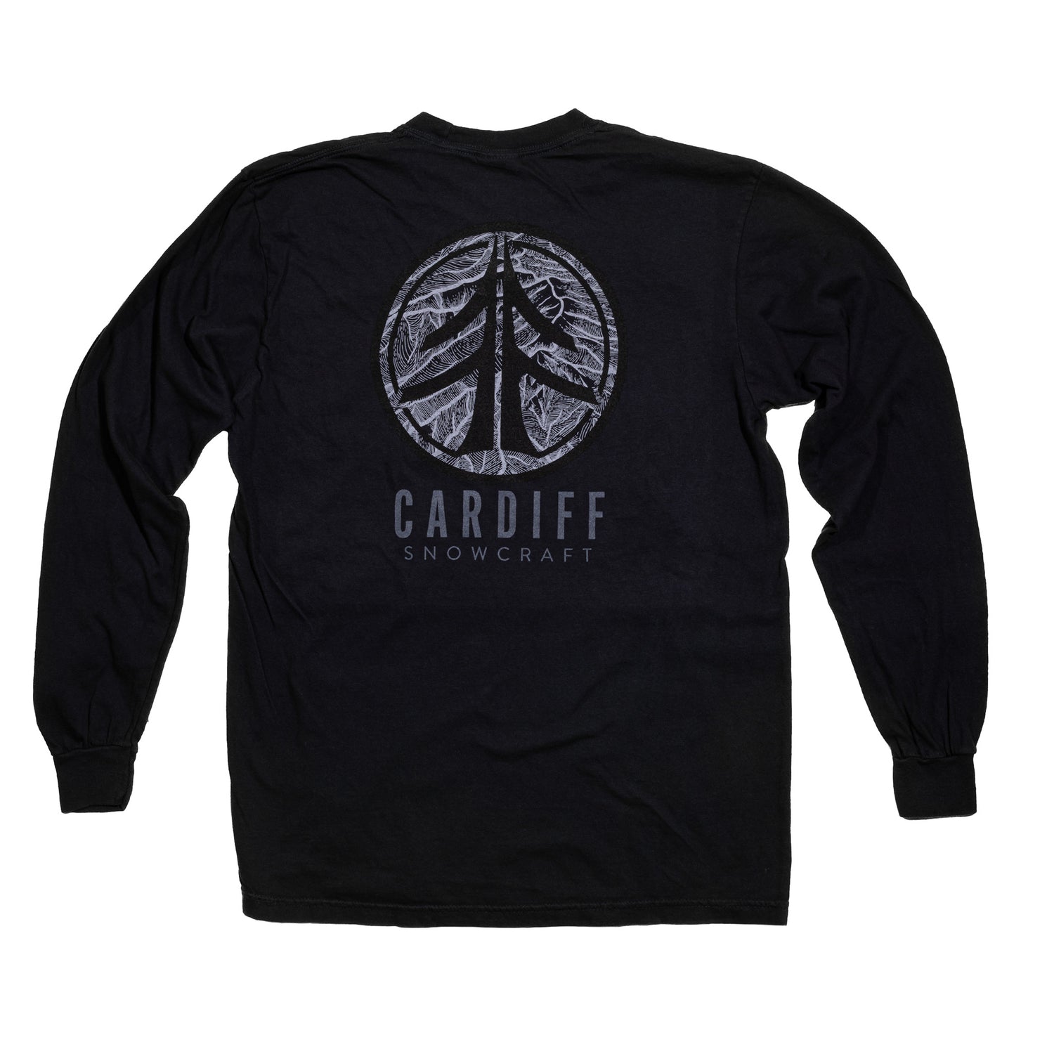 A man models the Wasatch Pocket Long Sleeve in a forest setting.